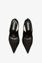 A Pointy Toe Satin Sling Back Pump In Black with a pointy toe and a label inside showing the brand name Victoria Beckham.