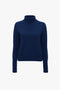 A Polo Neck Jumper In Navy by Victoria Beckham, with a regular fit and textured knit, displayed on a plain white background.