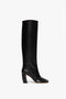 A single black, knee-high, pull-on leather Capri Rise Boot 115mm in Black by Victoria Beckham with a rounded toe, 115mm heel, and smooth finish, set against a plain white background.