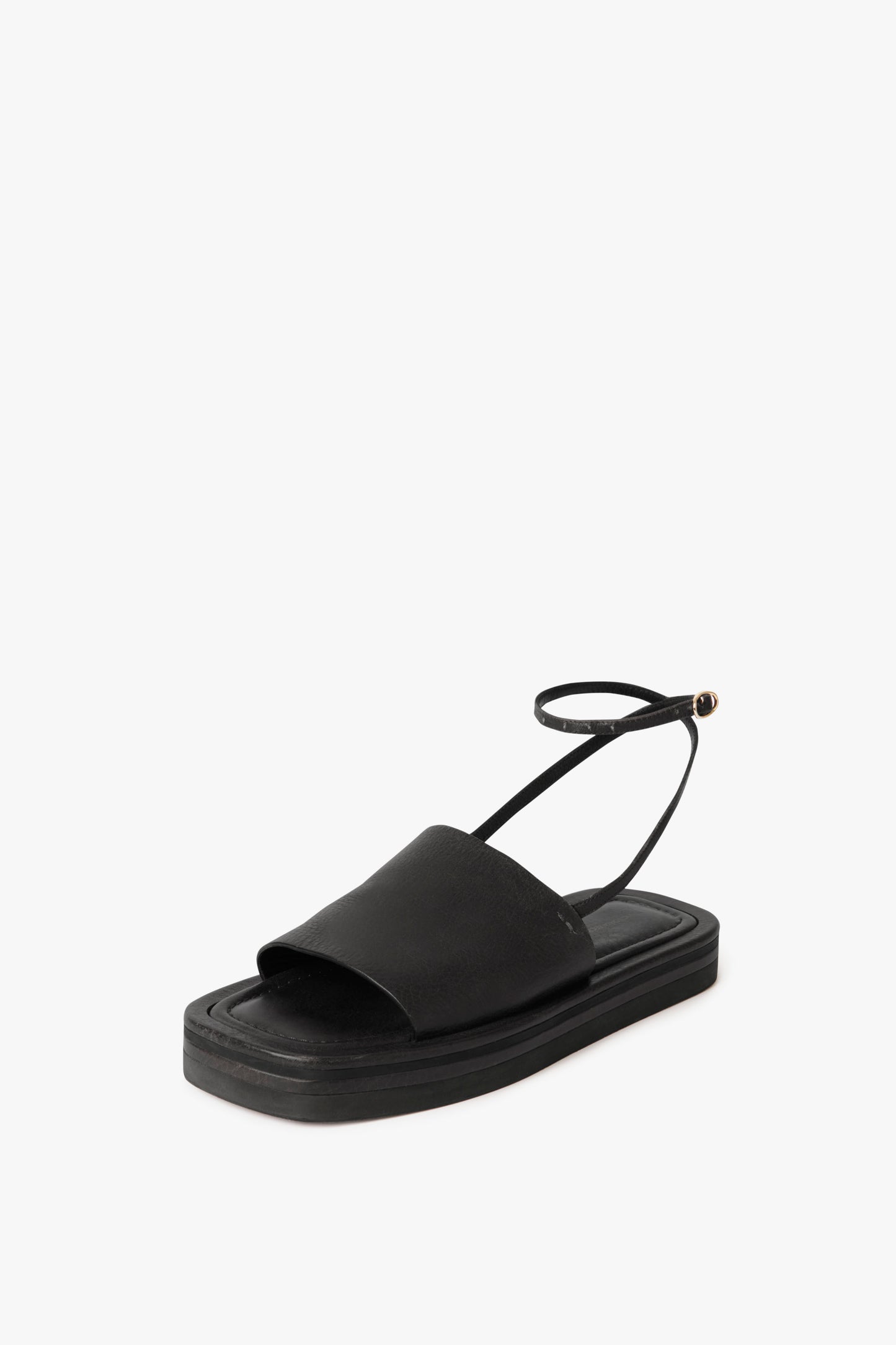 A single black Frances Sandal in Black by Victoria Beckham with an open toe, a minimalist leather band, a back strap, and a flat sole against a white background.