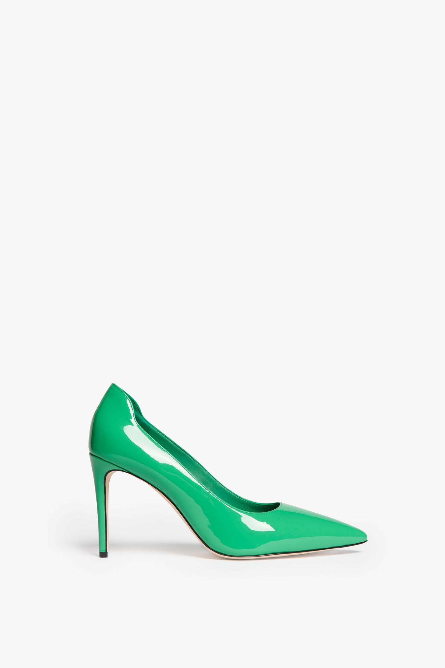 A VB 90mm Pump In Jade by Victoria Beckham featuring a single jade green patent leather high-heeled shoe with a pointed toe and a shiny surface, elegantly elevated by a 90mm stiletto heel.