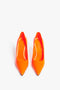 A pair of Victoria Beckham VB 90mm Pump In Fluorescent Orange with pointed toes and a 90mm stiletto heel, viewed from above against a white background.