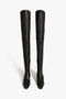 A pair of Victoria Beckham Camille Pumps In Black with pointed toes, sculptural heels, and side zippers, standing upright against a white background.