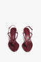 Pair of burgundy heeled sandals crafted from luxurious Bordeaux nappa leather with thin straps and square toes, displayed from above on a white background. The product is "Estelle in Bordeaux" by Victoria Beckham.