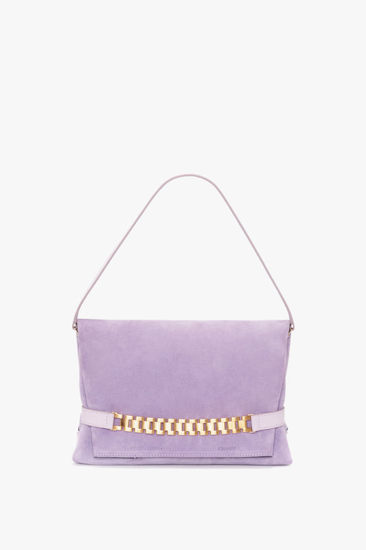 A Victoria Beckham Chain Pouch with Strap in Lilac Suede with a gold chain detail on the front and a single shoulder strap.