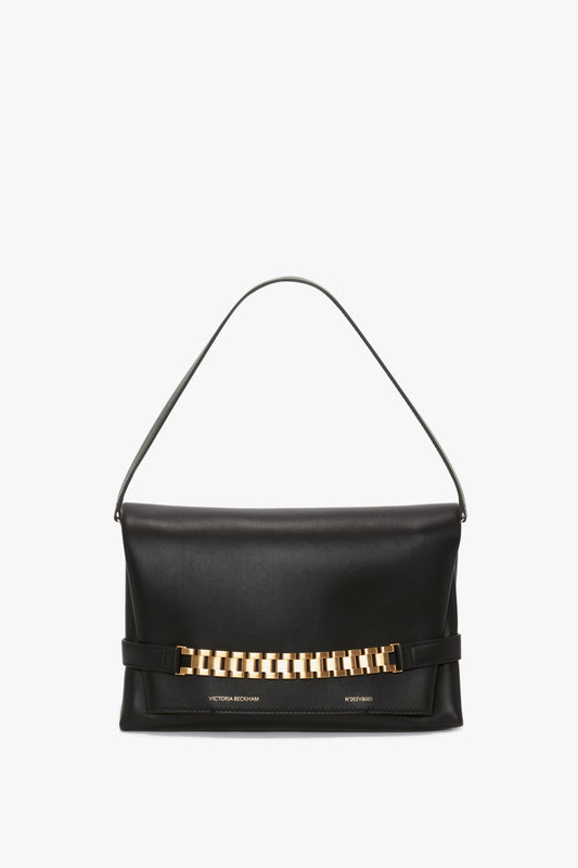 A versatile styling masterpiece, the Victoria Beckham Chain Pouch with Strap In Black Leather features a striking gold chain detail on the front and a single strap for effortless carrying.