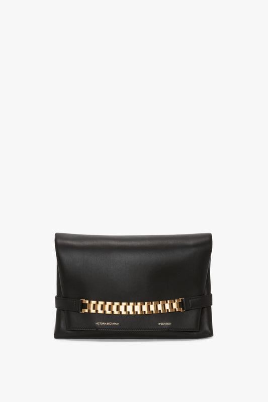 A Chain Pouch with Strap In Black Leather with a gold chain detail on the front and the text "Victoria Beckham" on the bottom, offering versatile styling options.