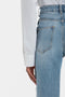 A person wearing a Victoria Beckham white Cropped Patch Pocket Shirt In White and blue high-waisted jeans is shown from the back, focusing on the lower torso and upper leg area.