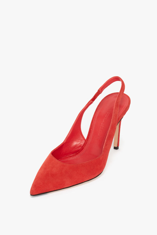 V Cut Slingback Pump In Orange Suede by Victoria Beckham with pointed toe and stiletto heel, reminiscent of Victoria Beckham tailoring, displayed on a white background.