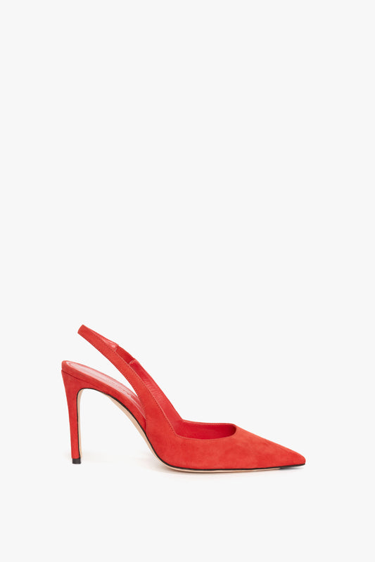 A single V Cut Slingback Pump In Orange Suede by Victoria Beckham, with a pointed toe and slingback design, echoing the sophistication of Victoria Beckham tailoring, is set against a white background.