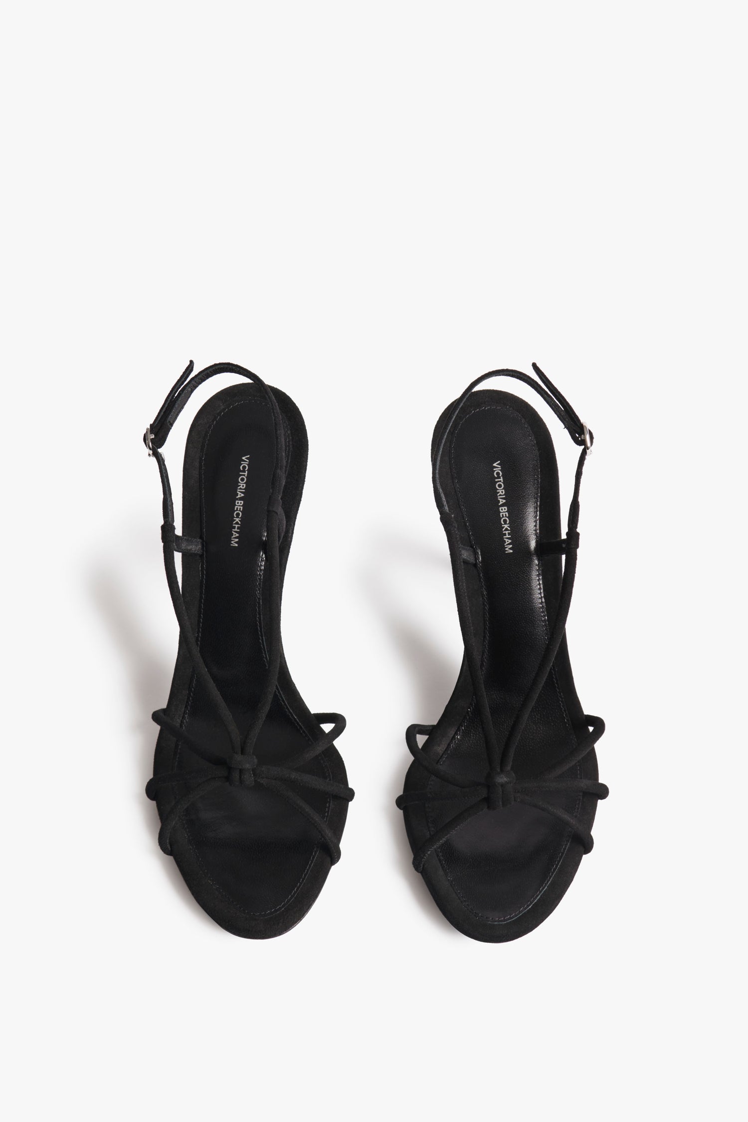 The Gaia Sandals from Victoria Beckham with a thin, mid-heel design. In black suede with an almond-toe design. A naked, barely-there heeled sandal look.